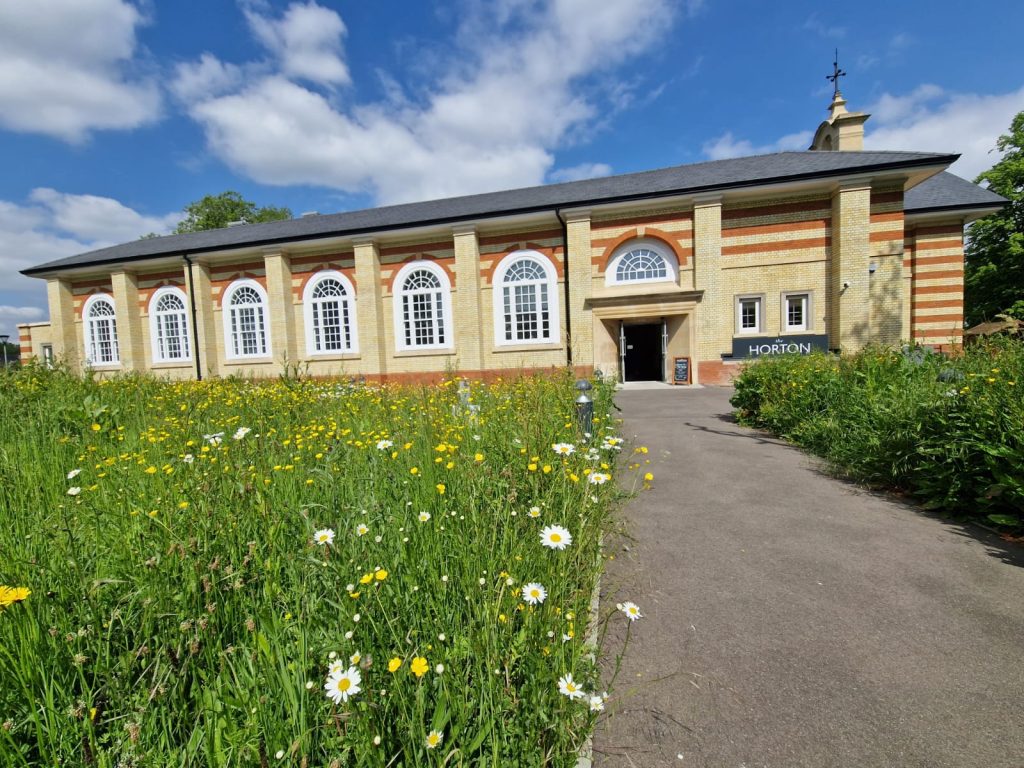 Exterior of Horton Epsom building with Spring flowers landscape